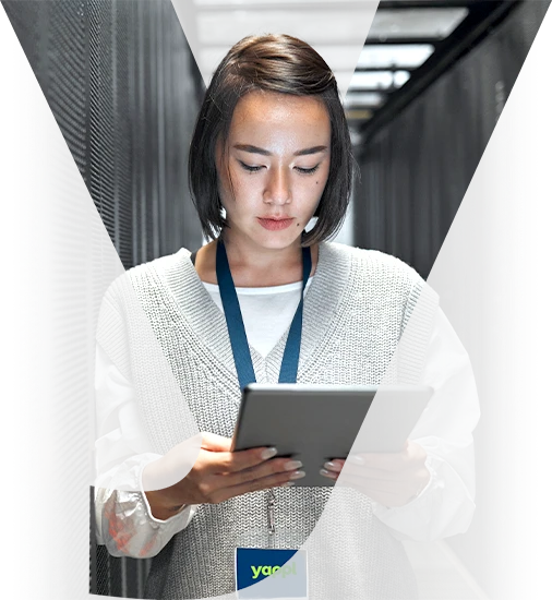 Network technician using a tablet in a server room