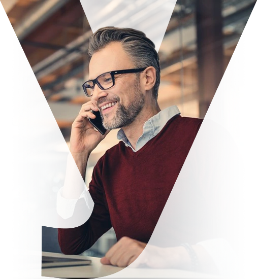 Business professional making a mobile call at his desk