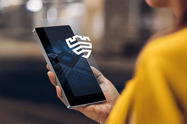 Hand holding a Samsung smartphone displaying a Samsung Knox security graphic