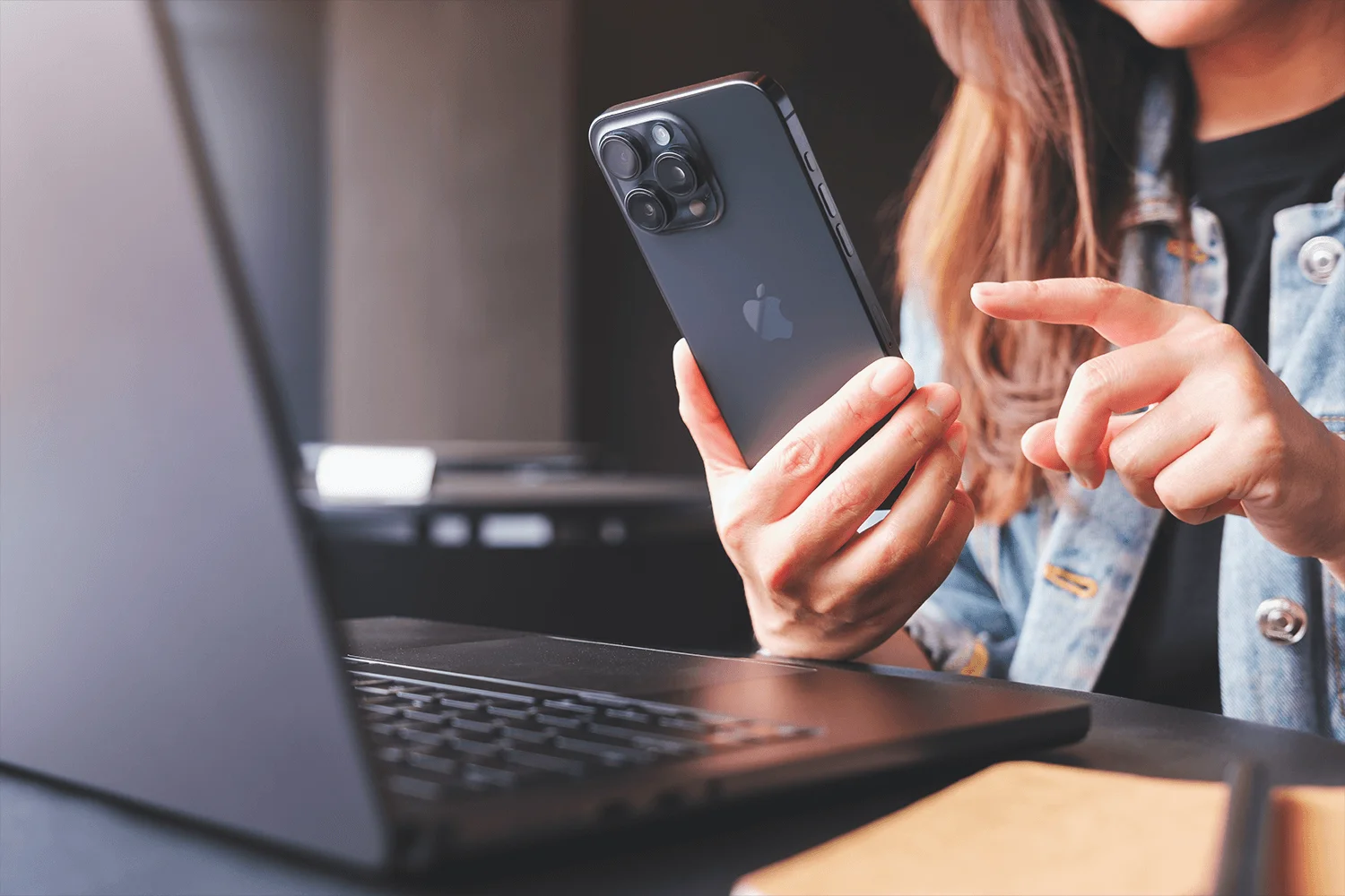 Close-up of a working professional in an office space using a mobile phone