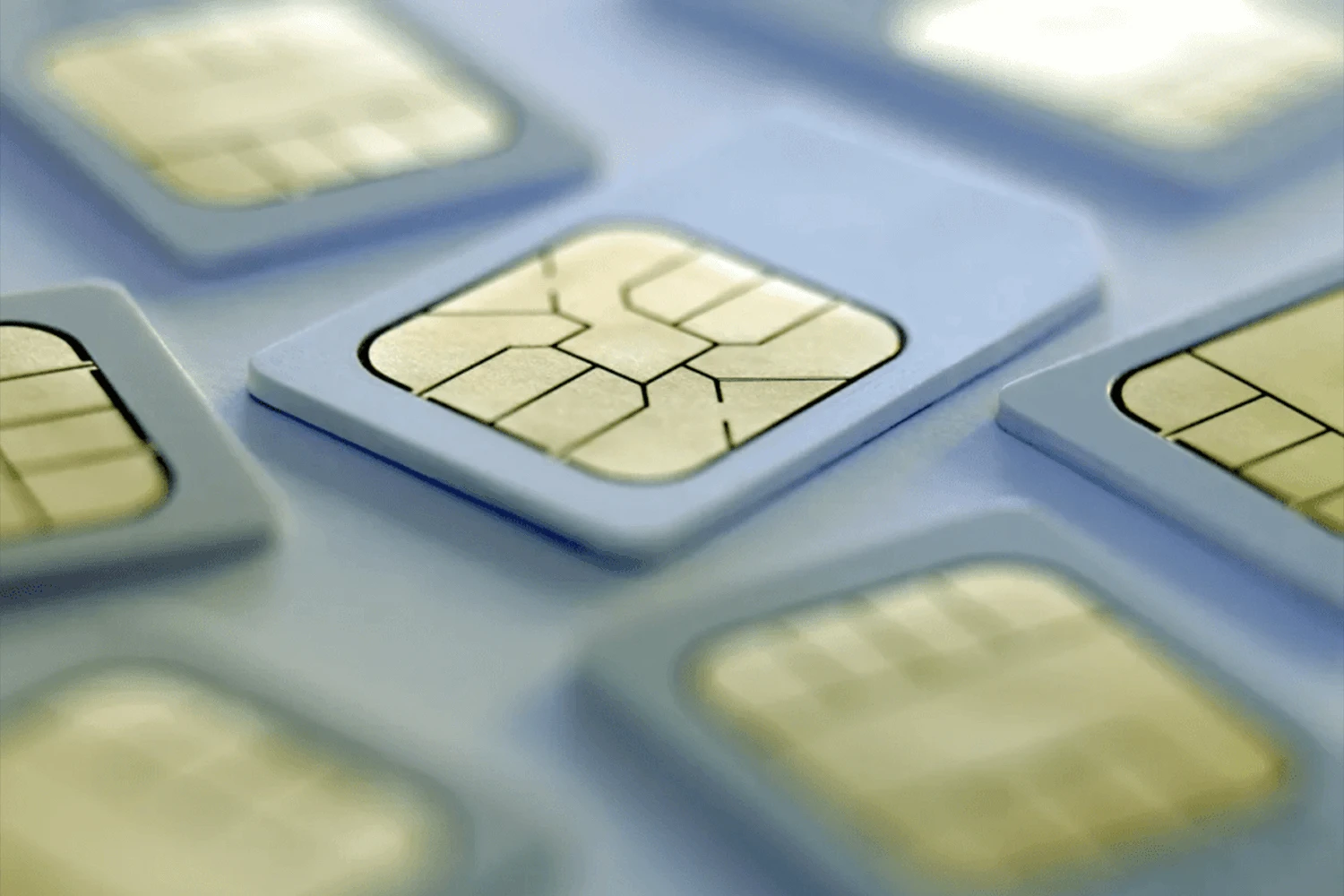 Multiple sim cards laying flat on a white surface