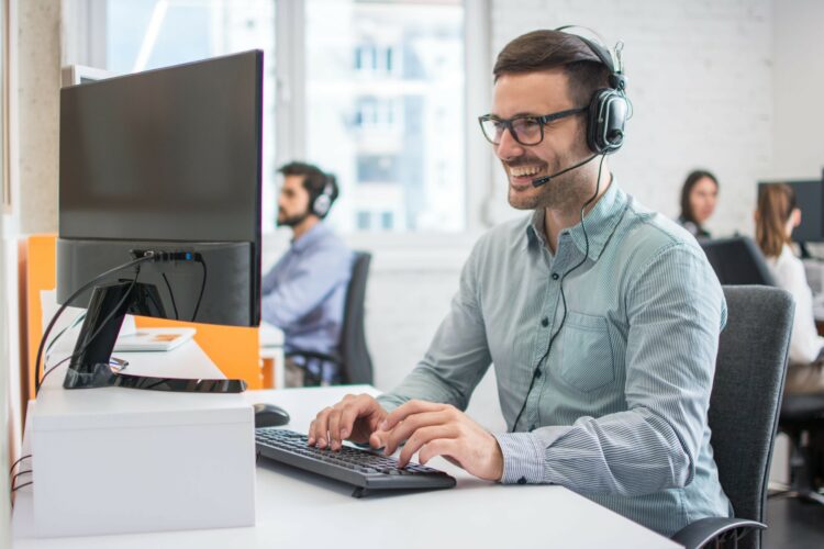 Smiling,Handsome,Male,Customer,Support,Phone,Operator,With,Headset,Working